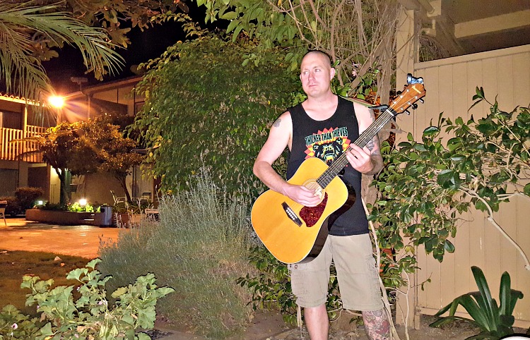 Brian playing guitar on our patio at the Best Western Peppertree Inn