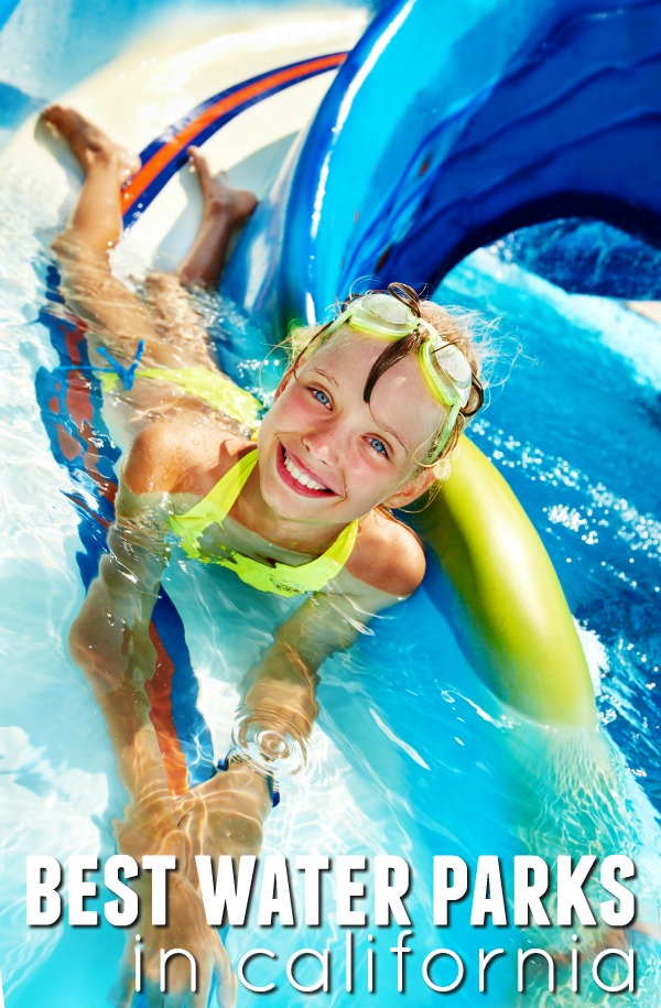 Little girl wearing goggles on her forehead at the bottom of the water slide