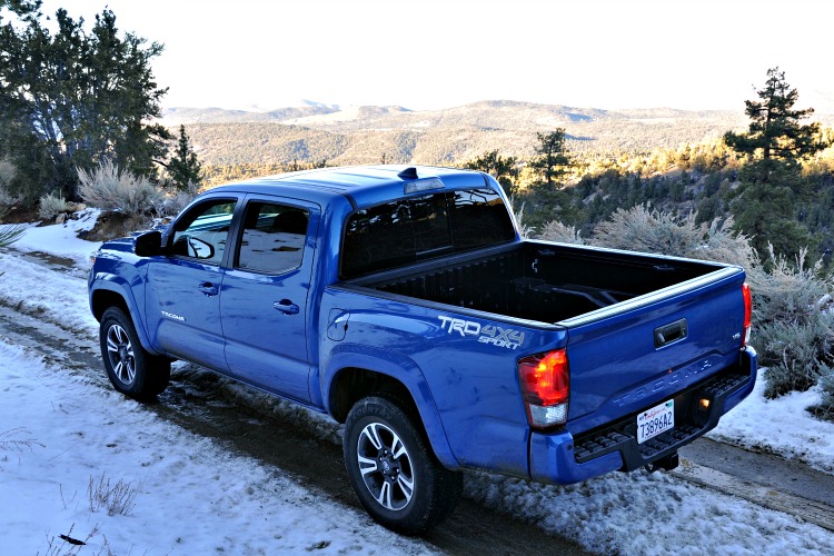 View of blue Toyota Tacoma from the hill above