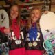 Zoë and Kaylee holding their snowboards in Mammoth