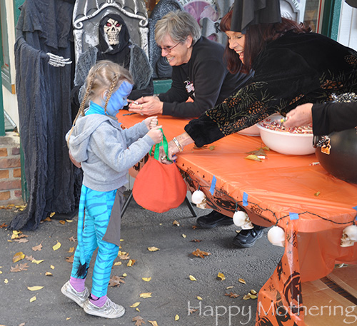 Zoe getting candy on Halloween