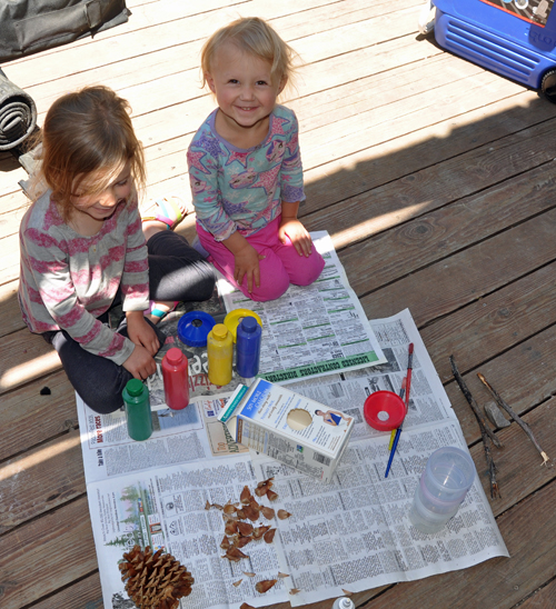 The girls working on their milk carton bird house