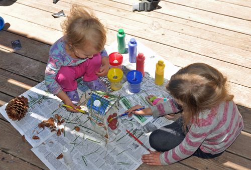 Zoë and Kaylee painting their milk carton bird house