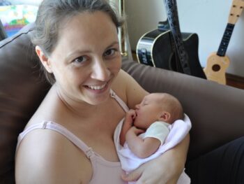Chrystal holding Kaylee after breastfeeding