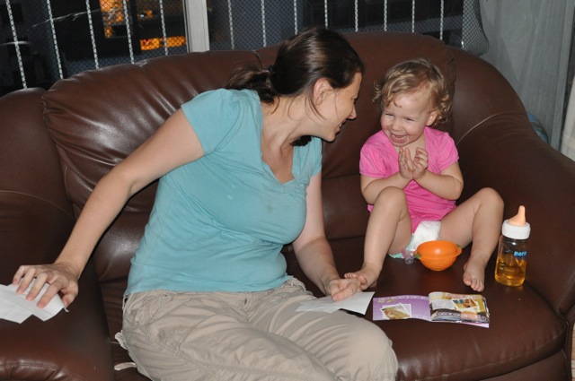 Chrystal making Zoë laugh on the couch in Uruguay