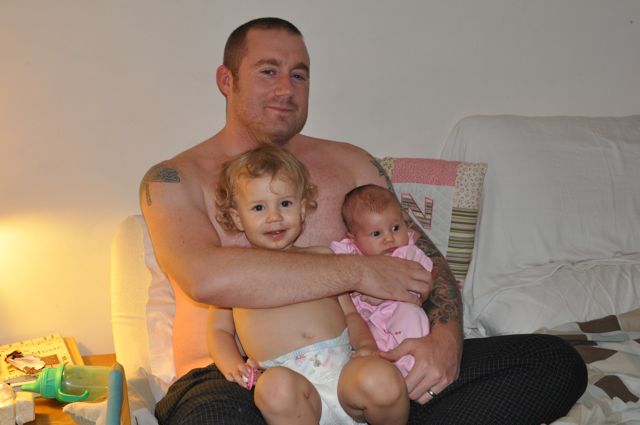 Brian holding Zoë and baby Kaylee in Uruguay bedroom