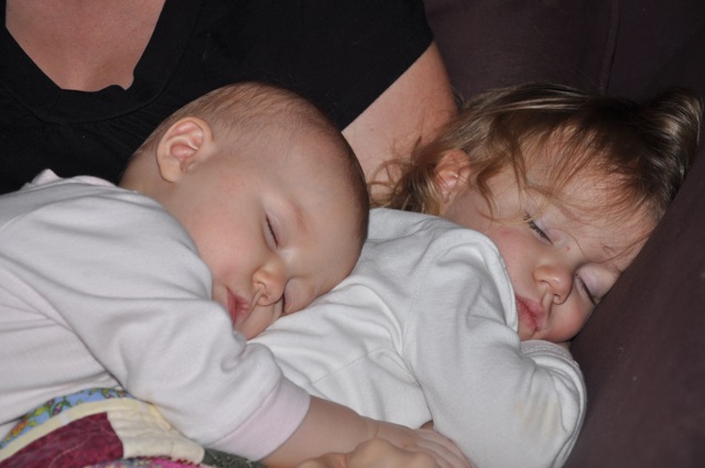 Zoë and Kaylee sleeping together in Chrystal's lap