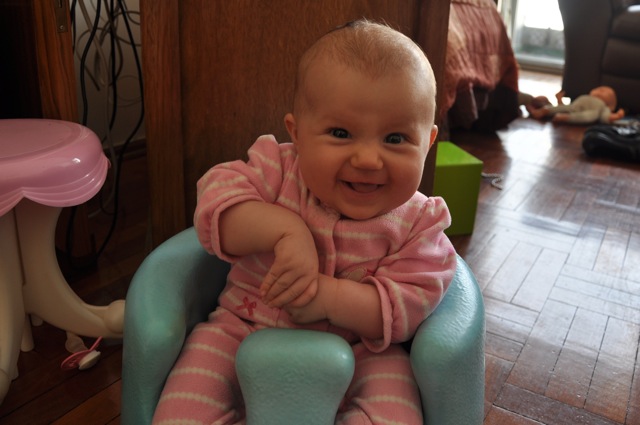 Kaylee smiling in her Bumbo seat