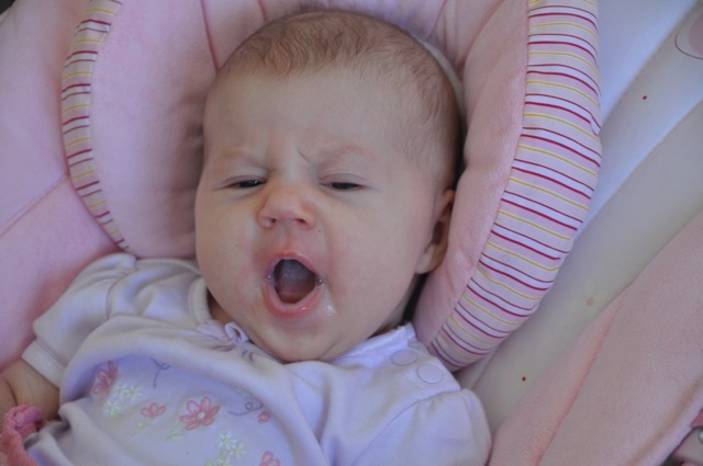 Kaylee yawning in her bouncy chair