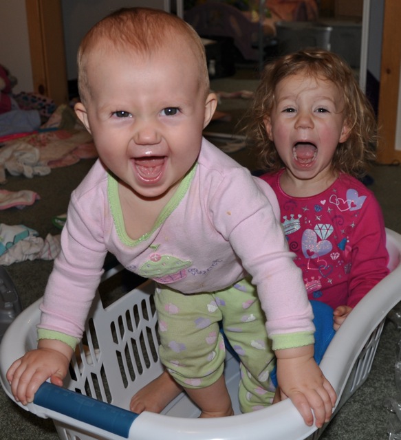 Zoë and Kaylee playing in the laundry basket