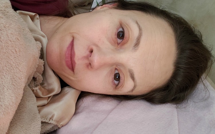 Chrystal laying in bed