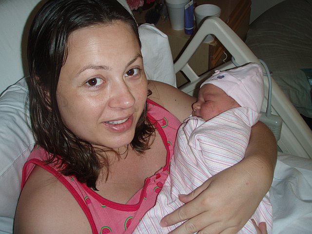 Chrystal holding baby Zoe in hospital bed