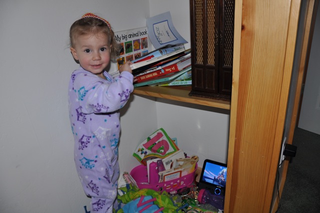 Zoë organizing her books in the closet