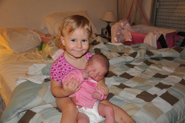 Zoë holding Kaylee on our bed