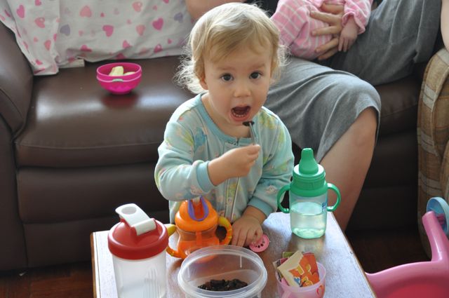 Zoë eating raisins with a fork