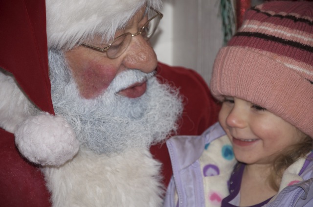 Zoë smiling on Santa's lap