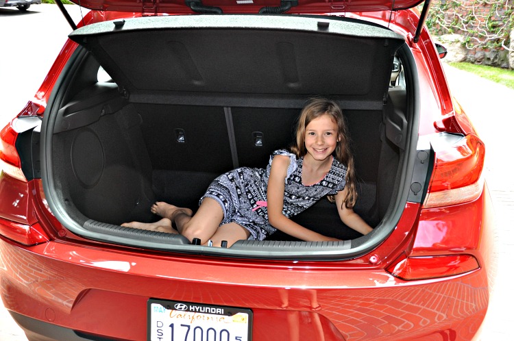 Zoë showing how big the trunk is in the Hyundai Elantra GT by sitting in it