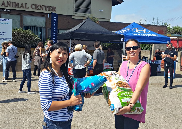 Chrystal and TerriAnn donating pet food to Helen Woodward Animal Hospital in Rancho Santa Fe, CA