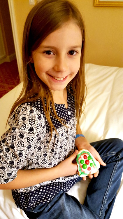 Zoë holding the cookie she decorated