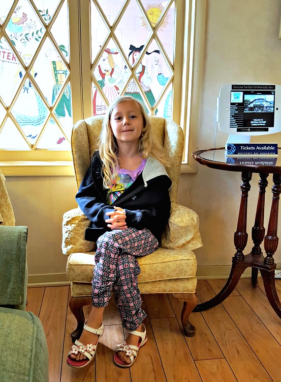 Kaylee sitting in the kids chair in the Hofsas House lobby