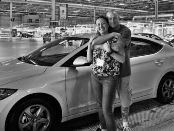 Brian and Chrystal standing by a Hyundai Elantra Eco