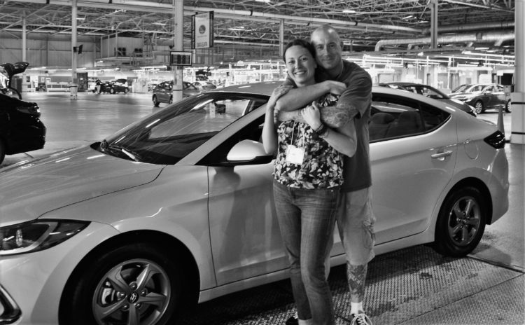 Brian and Chrystal standing by a Hyundai Elantra Eco