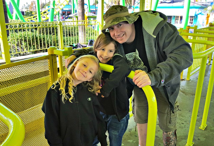 Brian and the girls waiting for a roller coaster