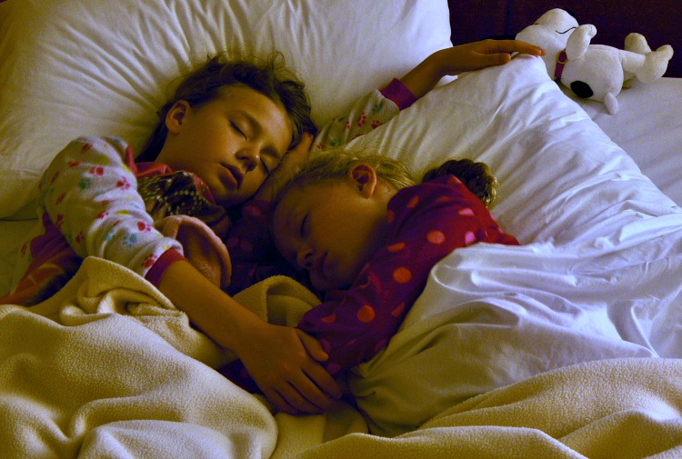 Zoë and Kaylee sleeping on the pull out couch at the Marriott Courtyard