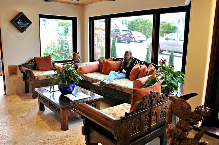 Zoë sitting on the couch in the Pantai Inn lobby in La Jolla, CA