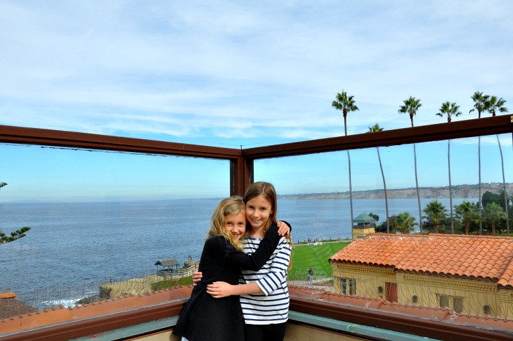Zoë and Kaylee on top of the Pantai Inn with sweeping ocean views in the background