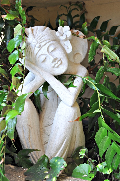 Balinese statue in the bushes at the Pantai Inn in La Jolla, CA