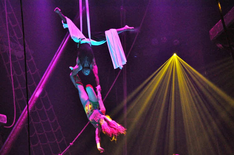 Acrobats flying through the air at the Pirate's Dinner Adventure show