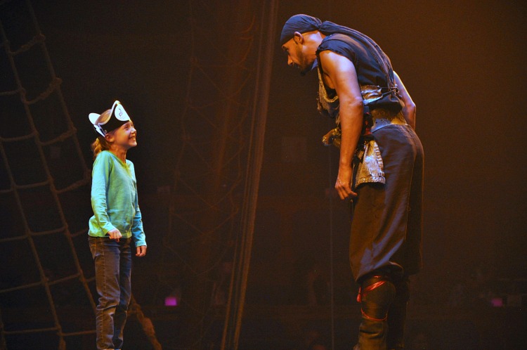 Kaylee on stage with a pirate at the Pirate's Dinner Adventure show