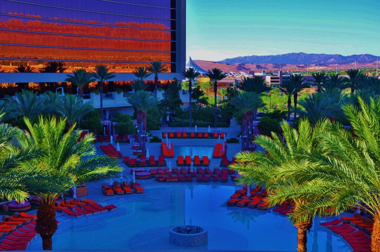 View of the amazing Red Rock pool surrounded by palm trees