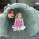 Kaylee sitting inside a hollow log at the Natural History Museum in San Diego, CA