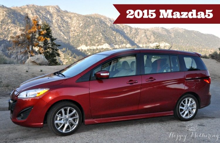 Red 2015 Mazda5 parked on the roads of arctic circle in the mountains