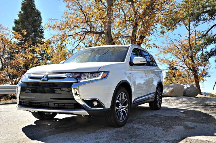 Front Angle of Mitsubishi Outlander GT under trees with yellow leaves