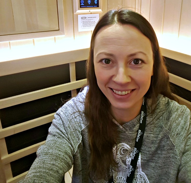 Chrystal in an infrared sauna at ShiftCon