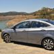 Gray Hyundai Accent GLS in front of water reservoir