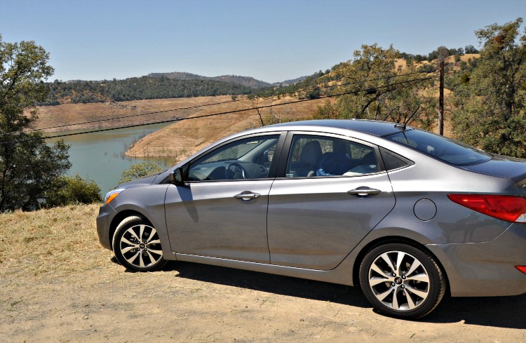 Gray Hyundai Accent GLS in front of water reservoir