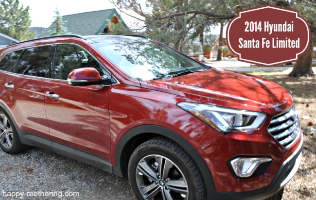 Red Hyundai Santa Fe in a rocky driveway