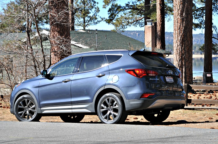 Hyundai Santa Fe Sport in front of Jeffrey Pine trees and Big Bear Lake