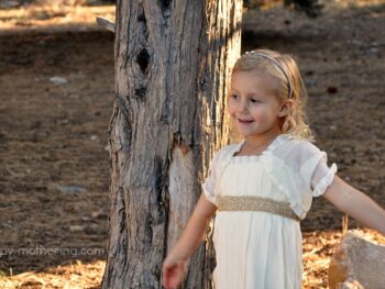Kaylee modeling her dress in front of a tree