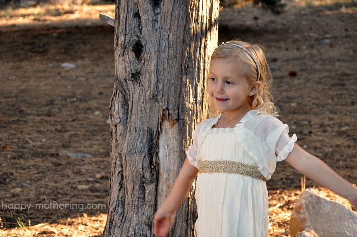 Kaylee modeling her dress in front of a tree