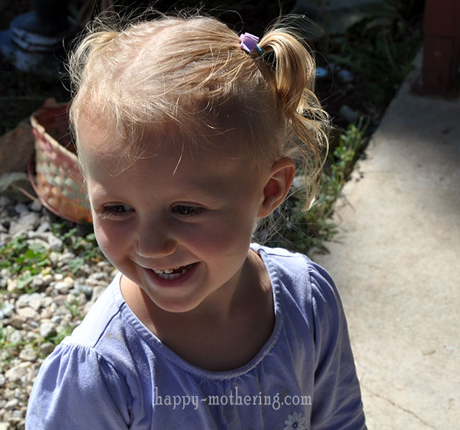 Kaylee smiling outside with pigtails