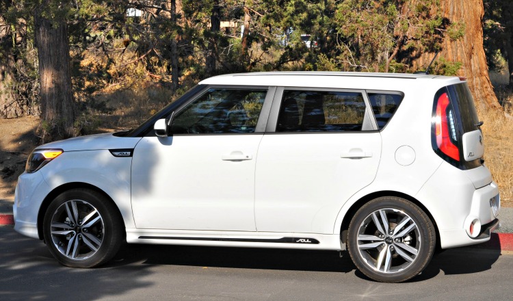 Side view of white Kia Soul in parking lot