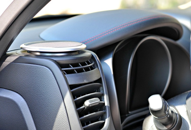 Speaker on dashboard of white Kia Soul