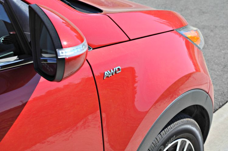 Red Kia Sportage with AWD emblem