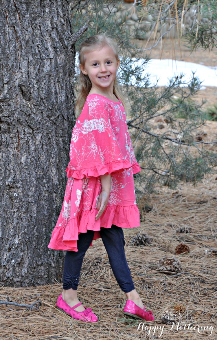 Kaylee modeling for Little Skye Boutique under a big pine tree