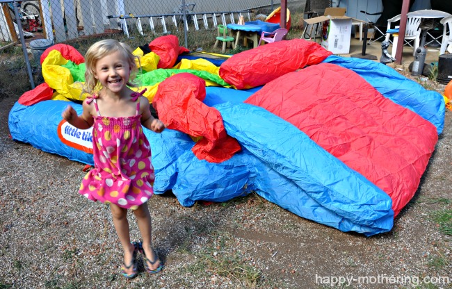 Kaylee jumping for joy while the bouncy house blows up